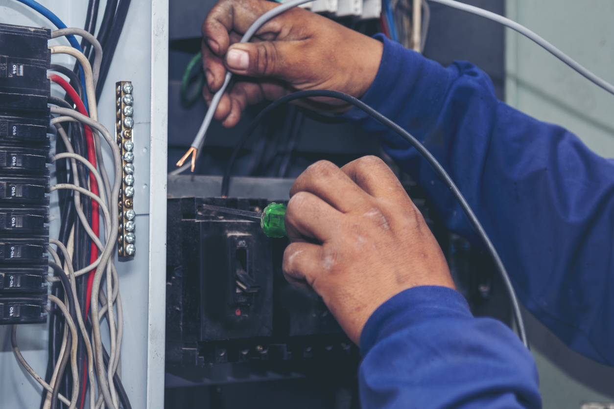 Electrician repairing circuit breaker