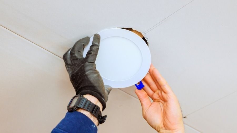 Electrician repairing and installing LED lights in ceiling of home
